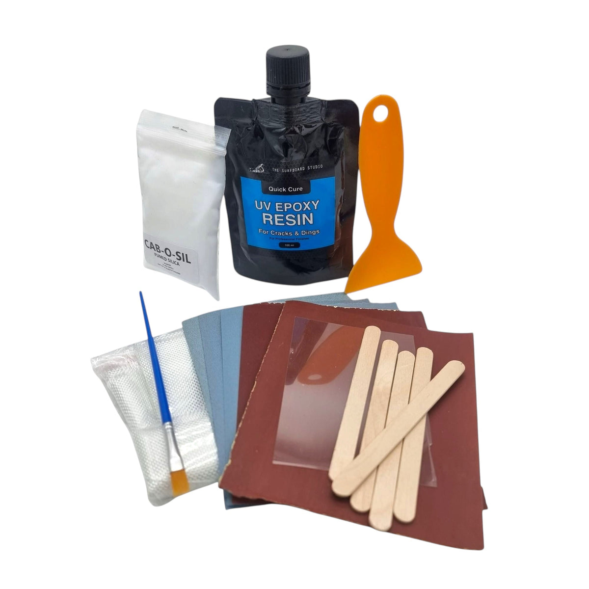 The Surfboard Studio UV Epoxy Repair Kit with resin, filler, fibreglass cloth, sandpaper and application tools laid out